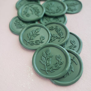dark green round wax seals with botanical leaves design