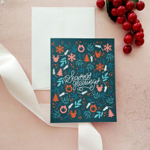 Load image into Gallery viewer, dark teal hoiliday greeting card with pink and red wintry illustrations and handlettered script