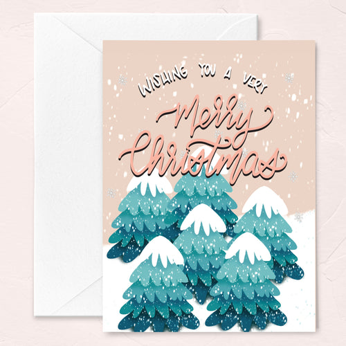 blush christmas greeting card with snow-covered trees at the tree farm illustration and script calligraphy