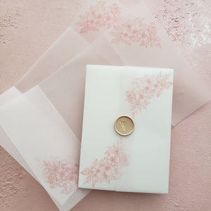 two pre-scored vellum wraps and one assembled clear vellum wraps with dusty rose florals