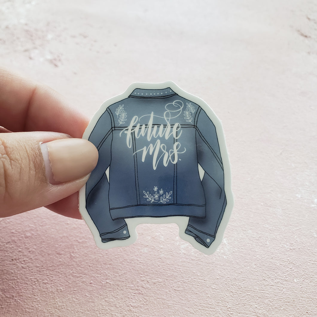 cute bridal vinyl sticker in the shape of a denim jacket with handlettering on it that says Future Mrs.