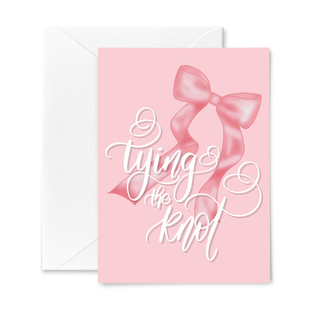 pink greeting card for weddings, bridal showers and bachelorettes featuring a trendy pink ribbon bow and calligraphy