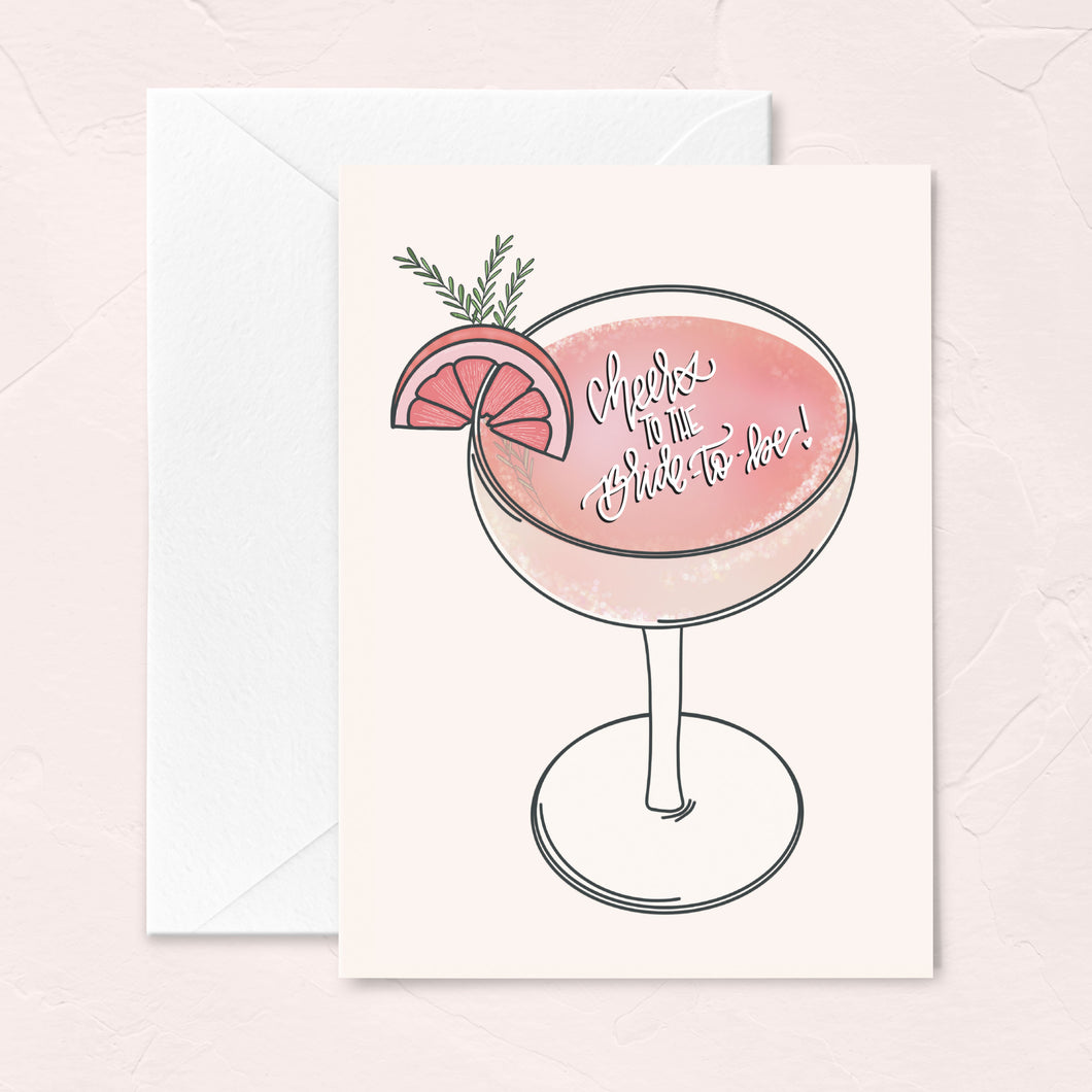 bridal shower greeting card with a pink and blush cocktail illustration - cheers to the bride-to-be