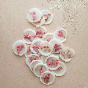dried pressed pink florals on vellum wax seals
