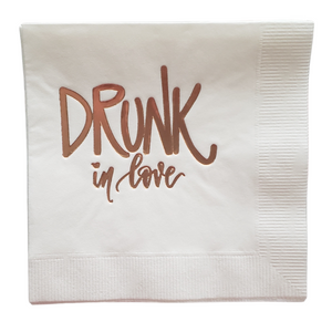 white paper cocktail napkins with "Drunk in love" foil stamped in rose gold for valentine's day and bachelorette parties
